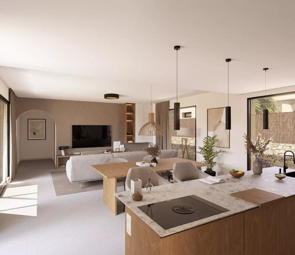 Open-plan living room and kitchen with marble island, three pendant lights, and a wall-mounted TV on a neutral backdrop.