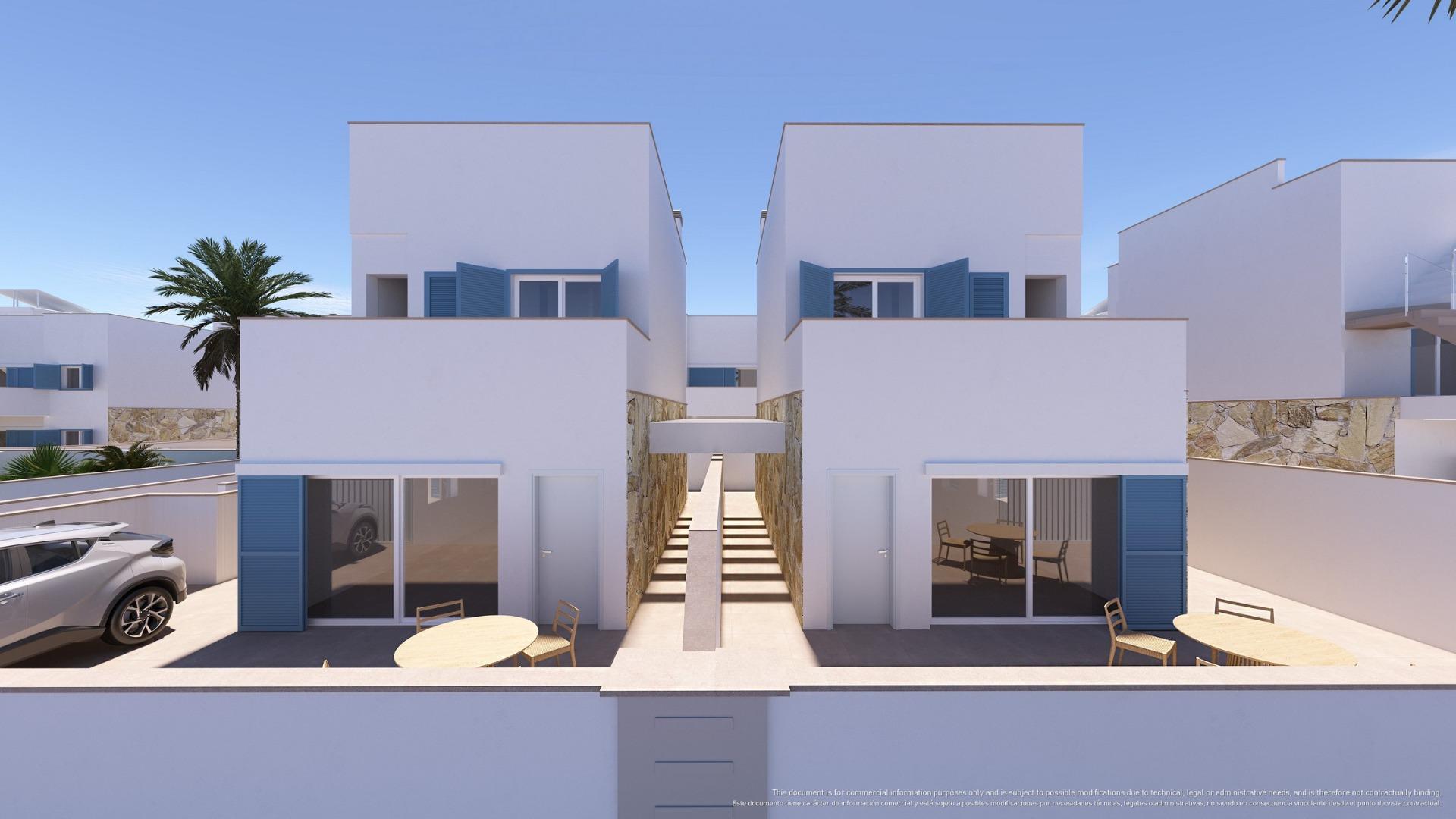 Row of white modern townhouses with blue shutters, a central walkway, stone walls, and outdoor seating under a clear blue sky.