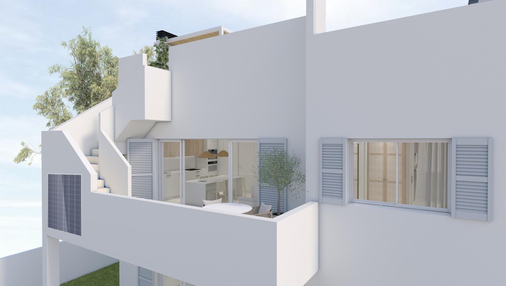 Modern white apartment exterior with glass doors opening to a balcony and dining set on a sunny terrace.