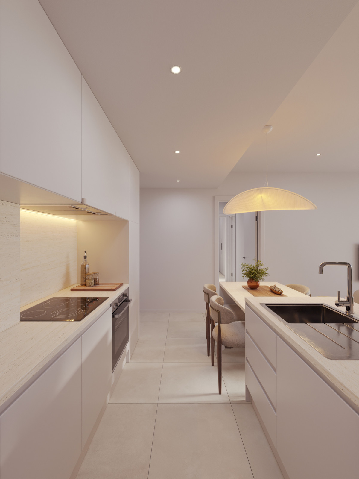 Bright white kitchen with an island, built-in stove and oven, and a warm pendant light over the dining table area.